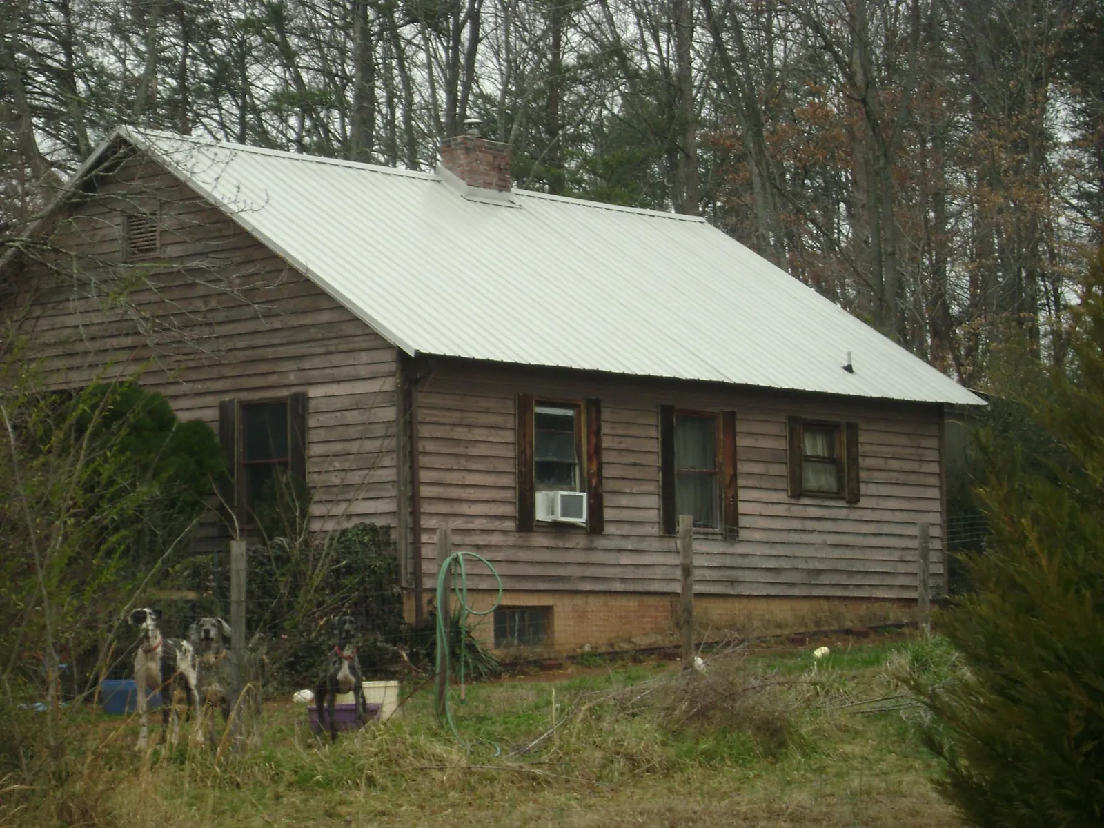 White metal roof on an old wood sided farmhouse, from a Metal Roof Installation job in North Henderson